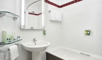 Guest bathroom with shower and tub at Leonardo Hotel Liverpool.