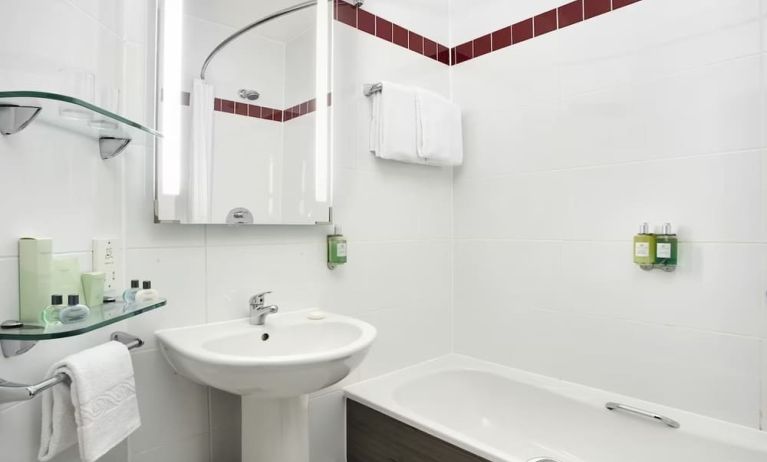 Guest bathroom with shower and tub at Leonardo Hotel Liverpool.