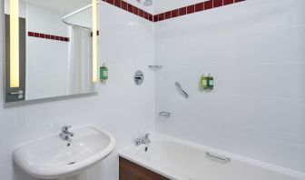 Guest bathroom with shower and tub at Leonardo Hotel Milton Keynes.