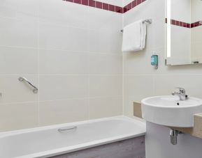 Guest bathroom with shower and tub at Leonardo Hotel Sheffield.