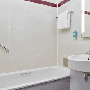 Guest bathroom with shower and tub at Leonardo Hotel Sheffield.