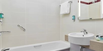 Guest bathroom with shower and tub at Leonardo Hotel Sheffield.