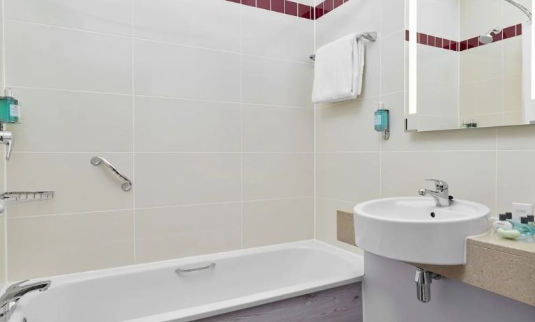 Guest bathroom with shower and tub at Leonardo Hotel Sheffield.