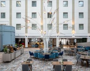 Dining area and lounge at Leonardo Royal Hotel Brighton Waterfront.