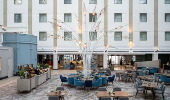 Dining area and lounge at Leonardo Royal Hotel Brighton Waterfront.