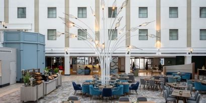 Dining area and lounge at Leonardo Royal Hotel Brighton Waterfront.