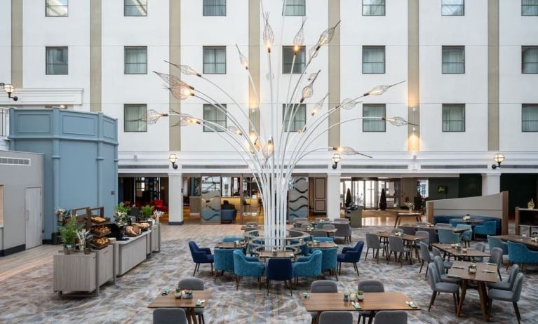 Dining area and lounge at Leonardo Royal Hotel Brighton Waterfront.