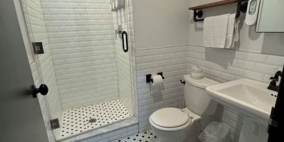 Guest bathroom with shower at Tribeca Hotel FiDi.