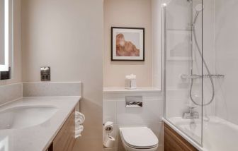 Guest bathroom with shower and tub at DoubleTree by Hilton Dartford Bridge.