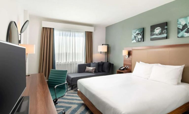 Comfortable delux king room with TV and work desk at Hilton Garden Inn London Heathrow Airport.