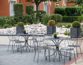 Seats and tables available in the garden at Hilton Northampton.