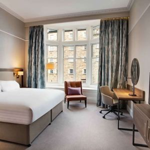 King bedroom with large window at Hilton Edinburgh Carlton.