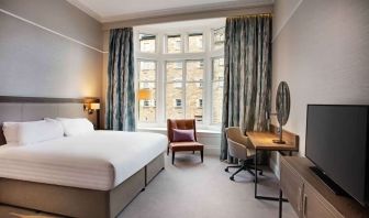 King bedroom with large window at Hilton Edinburgh Carlton.