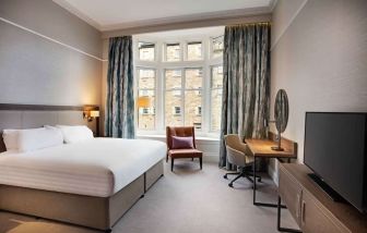 King bedroom with large window at Hilton Edinburgh Carlton.