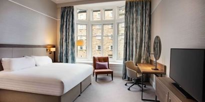 King bedroom with large window at Hilton Edinburgh Carlton.