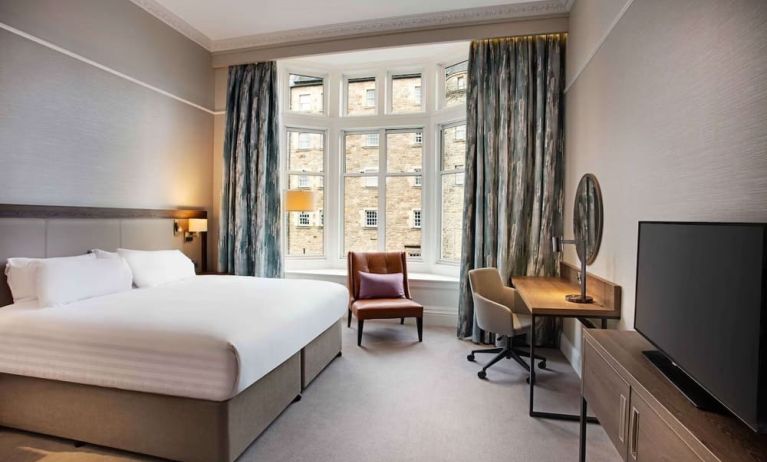 King bedroom with large window at Hilton Edinburgh Carlton.