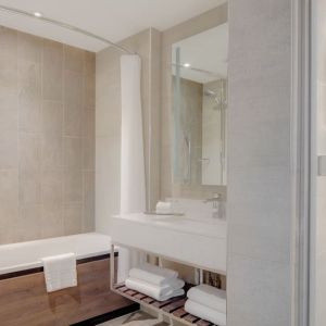 Guest bathroom with shower and tub at Hilton Edinburgh Carlton.