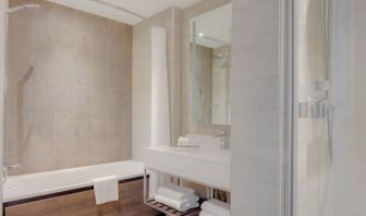 Guest bathroom with shower and tub at Hilton Edinburgh Carlton.