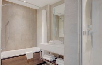 Guest bathroom with shower and tub at Hilton Edinburgh Carlton.