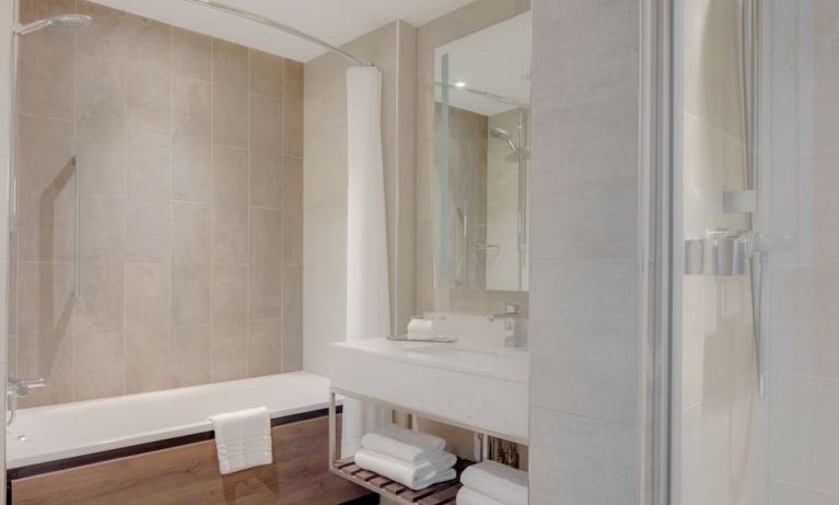 Guest bathroom with shower and tub at Hilton Edinburgh Carlton.