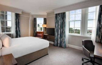 Day use room with large windows and work desk at Hilton Edinburgh Carlton.