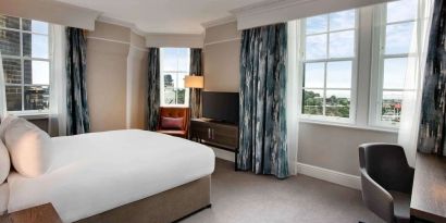 Day use room with large windows and work desk at Hilton Edinburgh Carlton.