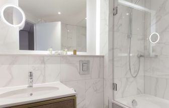 Guest bathroom with shower and tub at DoubleTree By Hilton Stoke On Trent.