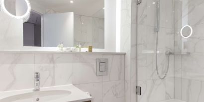 Guest bathroom with shower and tub at DoubleTree By Hilton Stoke On Trent.