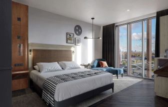 Bright king bedroom with view at The Gantry London, Curio Collection By Hilton.