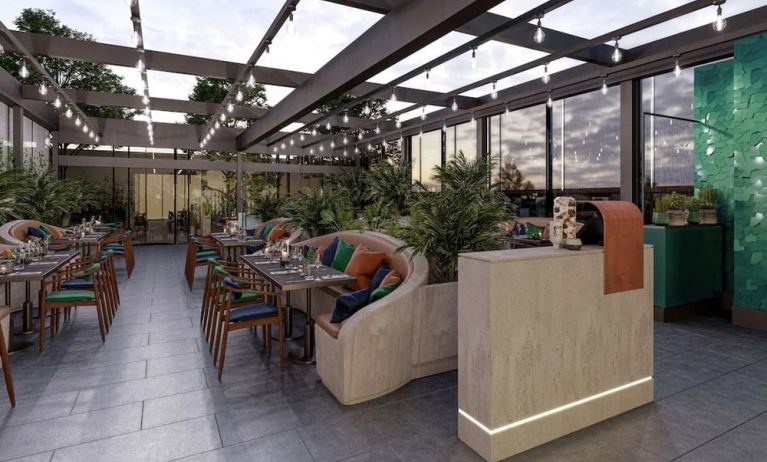 Dining area with natural light at The Gantry London, Curio Collection By Hilton.