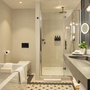 Guest bathroom with shower and tub at The Gantry London, Curio Collection By Hilton.