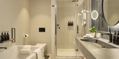 Guest bathroom with shower and tub at The Gantry London, Curio Collection By Hilton.