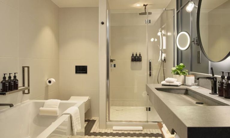 Guest bathroom with shower and tub at The Gantry London, Curio Collection By Hilton.