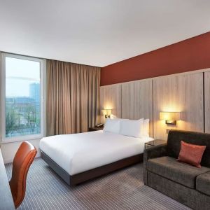 Day use room with sofa and large window at DoubleTree By Hilton London Excel.