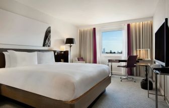 Delux king bed with work desk at Hilton London Angel Islington.
