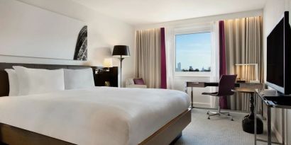 Delux king bed with work desk at Hilton London Angel Islington.
