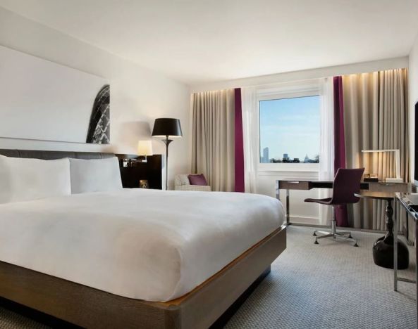 Delux king bed with work desk at Hilton London Angel Islington.
