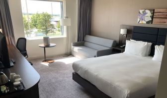 Day use room with work desk and sofa at Hilton Garden Inn Birmingham Airport.