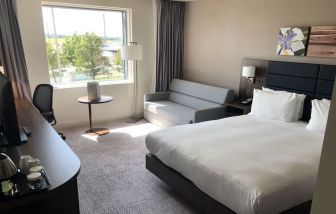 Day use room with work desk and sofa at Hilton Garden Inn Birmingham Airport.