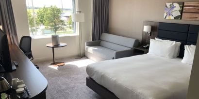 Day use room with work desk and sofa at Hilton Garden Inn Birmingham Airport.