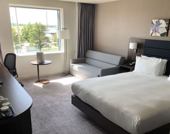 Day use room with work desk and sofa at Hilton Garden Inn Birmingham Airport.