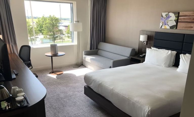 Day use room with work desk and sofa at Hilton Garden Inn Birmingham Airport.