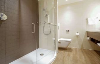 Guest bathroom with shower at Hilton Garden Inn Birmingham Airport.