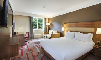 King guestroom with desk and sofa at the DoubleTree by Hilton Newbury North.