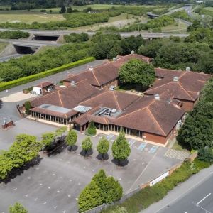 Hotel exterior with green surroundings at the DoubleTree by Hilton Newbury North.