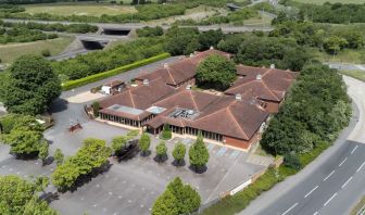 Hotel exterior with green sorroundings at the DoubleTree by Hilton Newbury North.