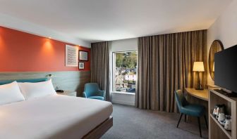 Luxurious king suite with TV and work desk at Hampton By Hilton Torquay.