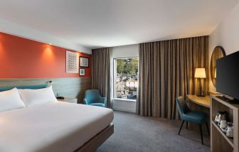 Luxurious king suite with TV and work desk at Hampton By Hilton Torquay.