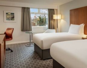 Day use room with double bed, work desk and TV at Hilton London Watford.