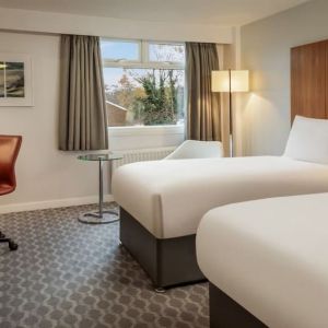 Day use room with double bed, work desk and TV at Hilton London Watford.